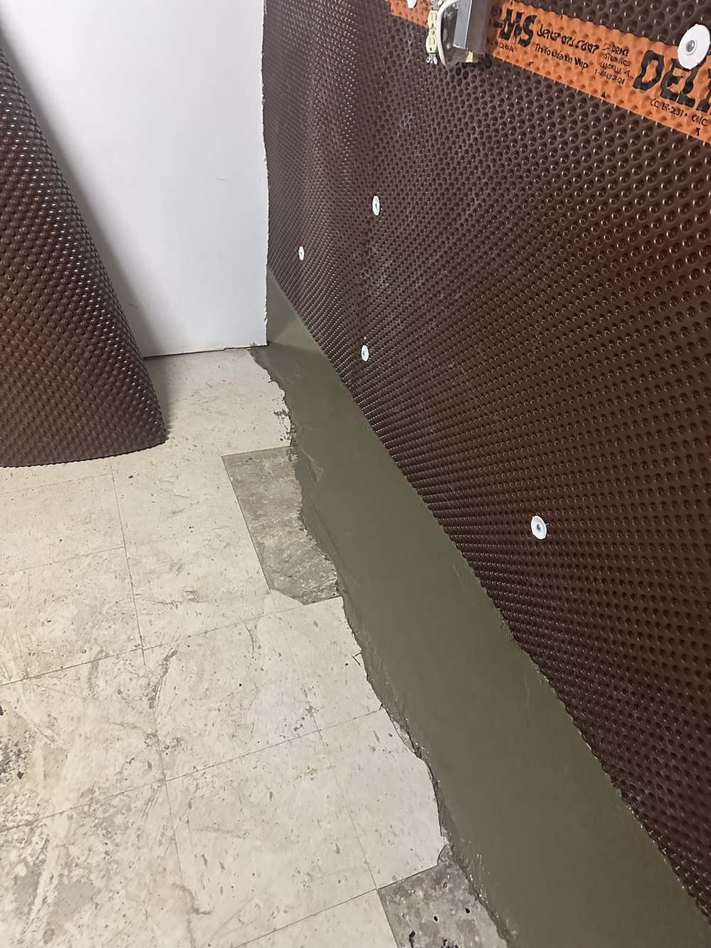 Finished interior waterproofing with membrane and a smooth new concrete curb